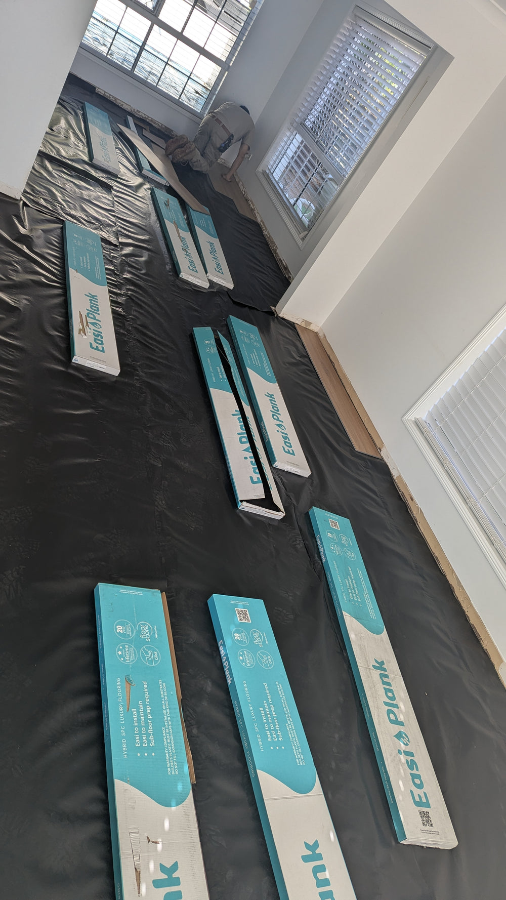 Flooring preparation with protective floor covering and East Plank boards ready for installation. - site preparation